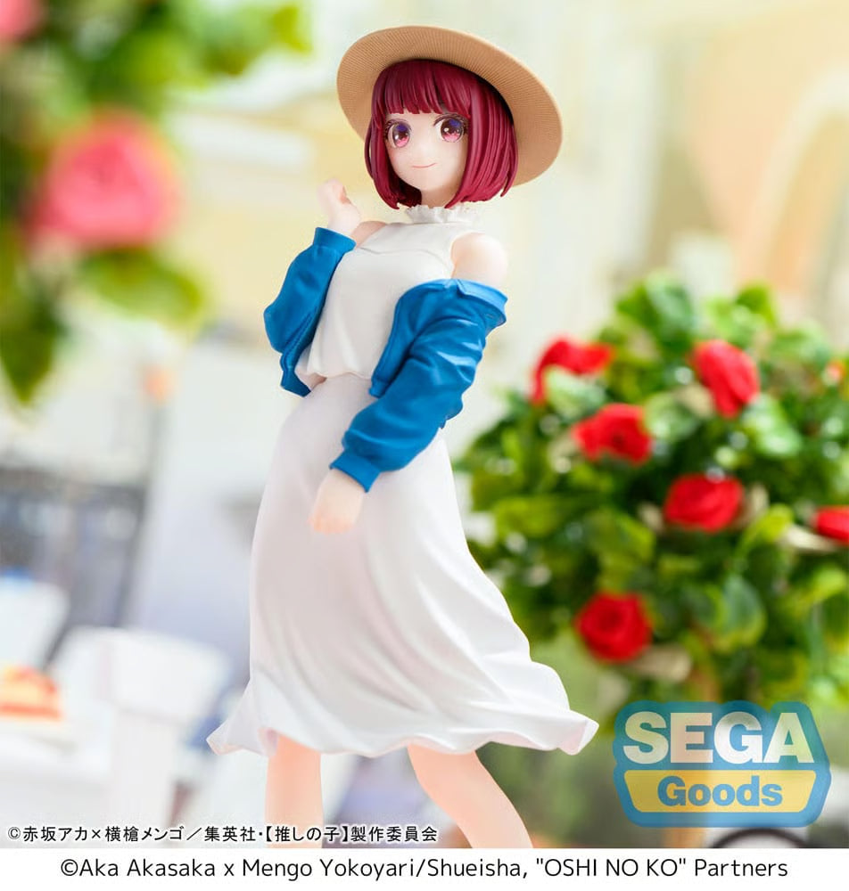 Figurine of a character with red hair and a white dress with blue sleeves, standing outdoors with flowers in the background. Sega Goods logo visible.