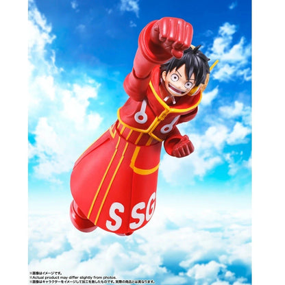 A collectible action figure of SLuffy from One Piece floating against a bright blue sky with white clouds. The figure is wearing his signature red and yellow SSG uniform and has 'SSG' printed on the side.