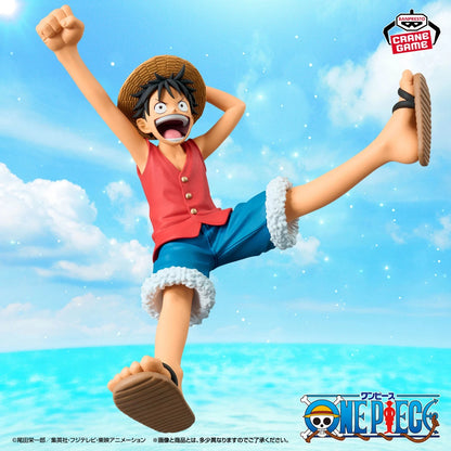 One Piece Grand Game figure of Monkey D. Luffy in a dynamic jumping pose against a blue sky and ocean background.