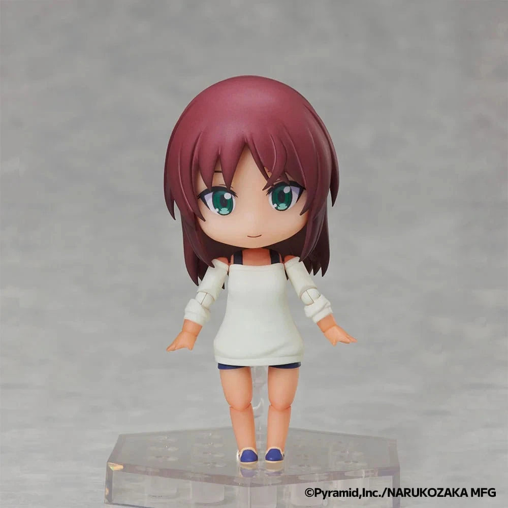 A chibi-style anime figurine with short burgundy hair, large teal eyes, and a white sleeveless dress, standing on a clear display base against a soft gray background.