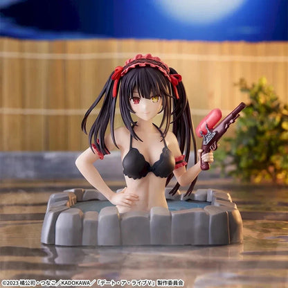 Anime figurine of a female character with long black hair and red accents, posed in a gray hot spring bath while holding a pinkish-red object, set against a blurred outdoor background.