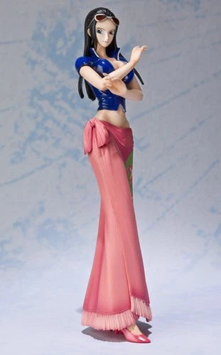 A collectible anime figurine of a female character with long black hair, wearing a blue crop top and a flowing pink skirt, posed against a light blue textured background.